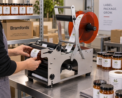 Semi-automatic bottle label applicator on stainless steel base