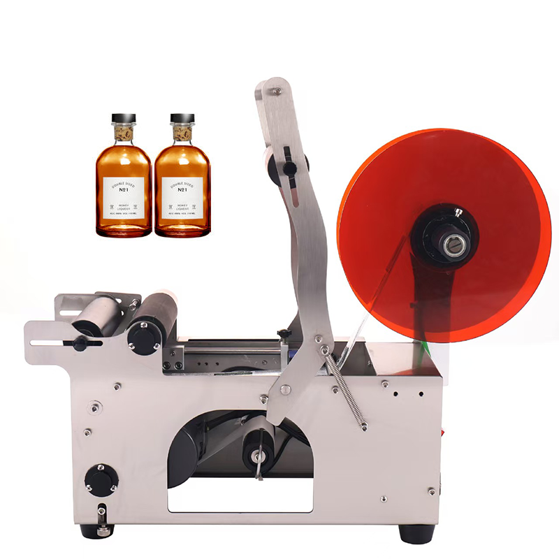 Side view of FRIENDPACK round bottle labelling machine with label roll and adjustable bottle rollers